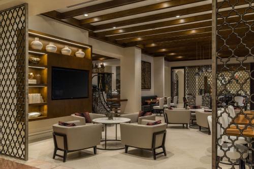 a restaurant with chairs and tables and a flat screen tv at Hyatt Regency Coral Gables in Miami in Miami