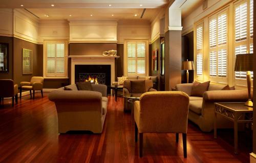 a living room filled with furniture and a fireplace at Hyatt Hotel Canberra - A Park Hyatt Hotel in Canberra