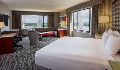 a hotel room with a large bed and a desk at Hyatt Regency Saint Louis at The Arch in Saint Louis