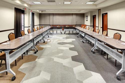 a large conference room with long tables and chairs at Hyatt Place Denver Airport in Aurora