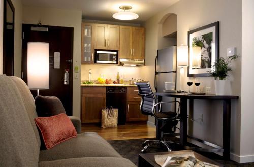 a living room with a couch and a kitchen at Hyatt House Philadelphia-King of Prussia in King of Prussia