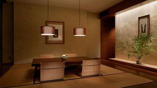 a dining room with a table and chairs and lights at Grand Hyatt Tokyo in Tokyo