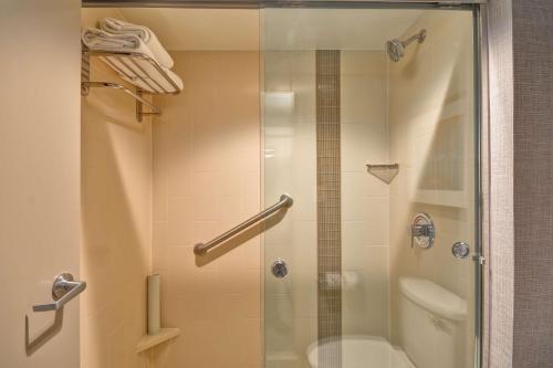 a shower with a glass door in a bathroom at Hyatt Place Baton Rouge/I-10 in Baton Rouge