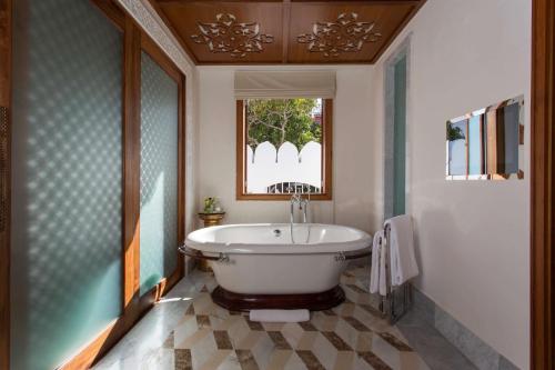 a bathroom with a tub and a window at Park Hyatt Zanzibar in Zanzibar City