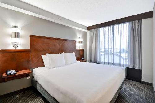 a hotel room with a large bed and a window at Hyatt Place Baton Rouge/I-10 in Baton Rouge