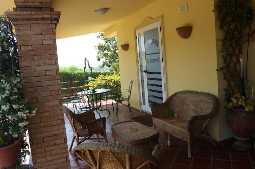 a patio with chairs and a table and a table at Villa Brunella in Agropoli