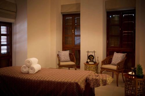 a bedroom with a bed with two towels on it at Park Hyatt Zanzibar in Zanzibar City