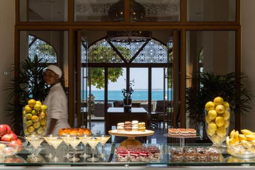a woman standing in front of a buffet of food at Park Hyatt Zanzibar in Zanzibar City