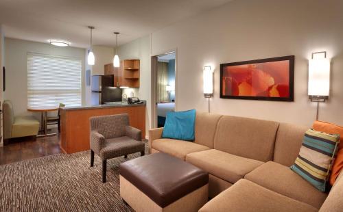 a living room with a couch and a chair at Hyatt House Salt Lake City/Sandy in Sandy