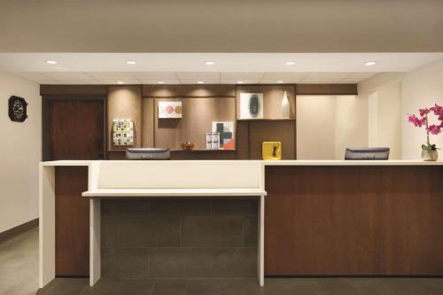 a lobby with a reception desk in a hospital at Hyatt House Miami Airport in Miami