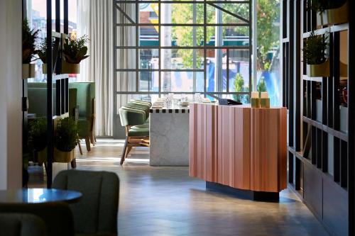 a room with a table and chairs and a large window at Andaz Ottawa Byward Market, By Hyatt in Ottawa
