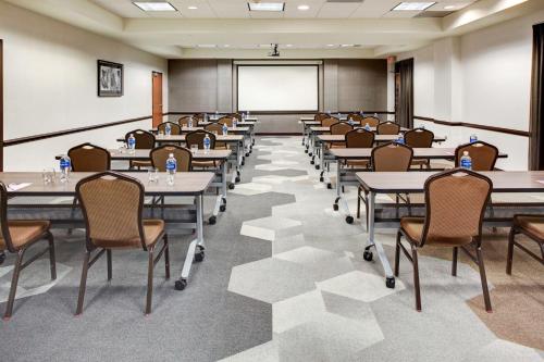 a classroom with tables and chairs and a projection screen at Hyatt Place Nashville Brentwood in Brentwood