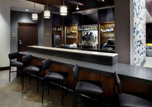 a bar in a restaurant with black chairs at Hyatt Place Atlanta Downtown in Atlanta