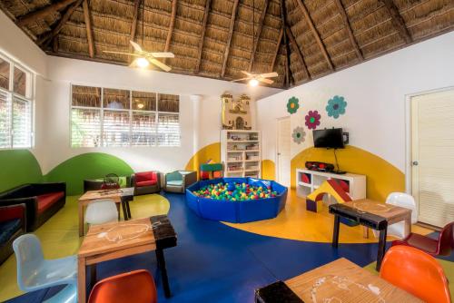 a room with a playroom with a large ball pit at Iberostar Waves Tucán in Playa del Carmen