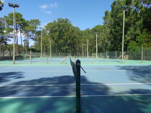 a tennis racket is on a tennis court at Green Park Departamentos Exclusivos in Punta del Este