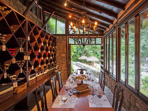 a dining room table with wine glasses on it at Inkaterra Machu Picchu Pueblo Hotel in Machu Picchu