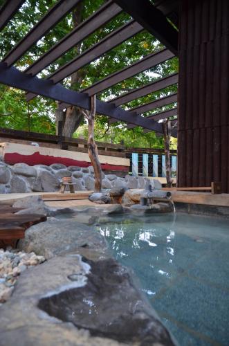 a swimming pool with a water fountain in a building at ARtINn 極寒藝術伝染装置 in Teshikaga