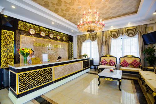 a lobby with a hair salon with a chandelier at Grand Hotel in Hòa Bình