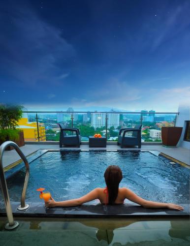 a woman laying in a swimming pool at a hotel at Castle Peak Hotel in Cebu City