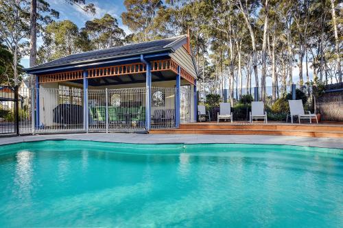 a large swimming pool in front of a large building at Waverley House Cottages in Lakes Entrance