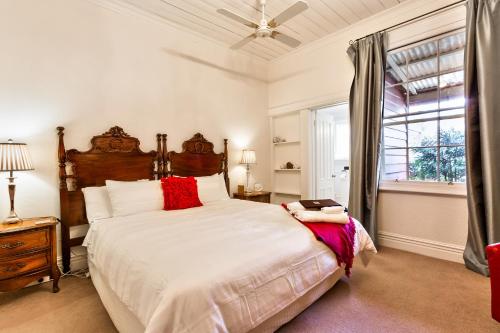 a bedroom with a large bed and a window at The Graces Beechworth in Beechworth