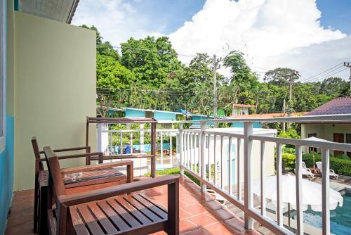 a balcony with two benches and a swimming pool at Aqua Beads Samed in Ko Samed