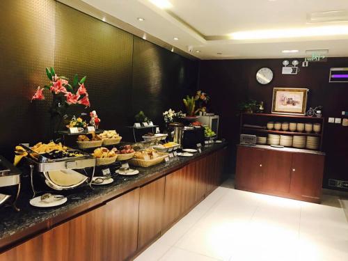 a buffet line in a hotel with food on it at Jinjiang Inn - Beijing Olympic Village Datun Road in Beijing