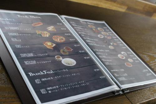 a menu for a restaurant on top of a table at Nangoku Lodge Booya in Onna