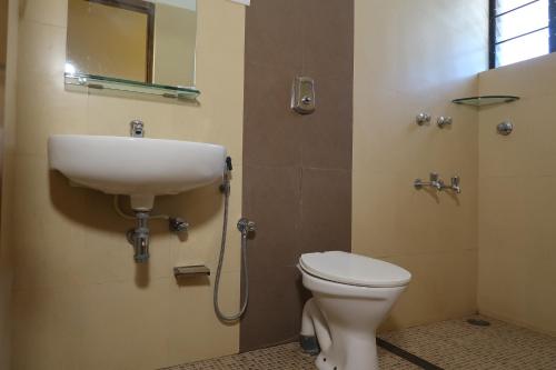 a bathroom with a sink and a toilet at Hotel Celi in Calangute