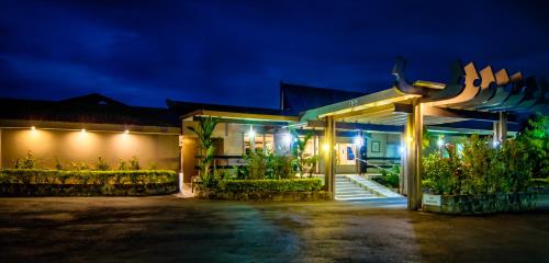 a house with a lit up facade at night at Tanoa Skylodge Hotel in Nadi
