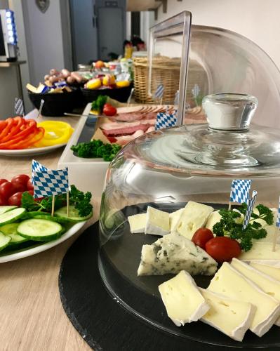 a buffet of food with cheese and vegetables on a table at CREO Munich City in Munich