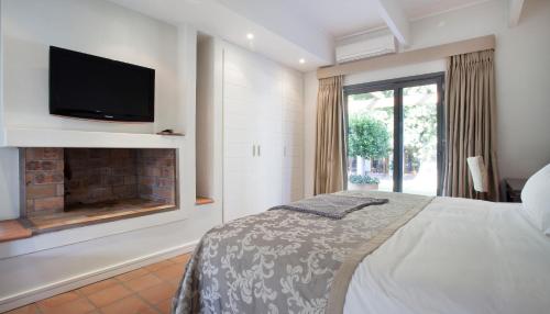 Ένα ή περισσότερα κρεβάτια σε δωμάτιο στο Klein Welmoed Luxury Guest House