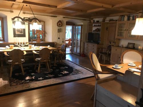 a kitchen and dining room with a table and chairs at Landhaus Kössel in Füssen