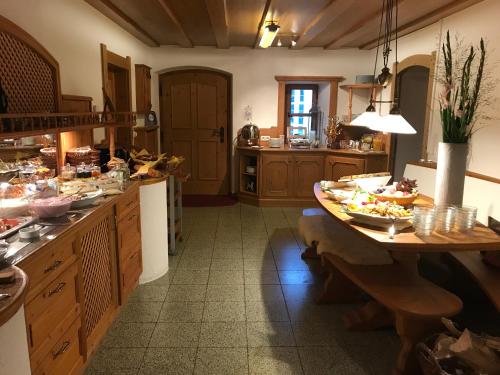 a kitchen with a table with food on it at Landhaus Kössel in Füssen