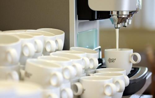 a group of coffee cups are being being brewed at Gästehaus Chorin in Chorin