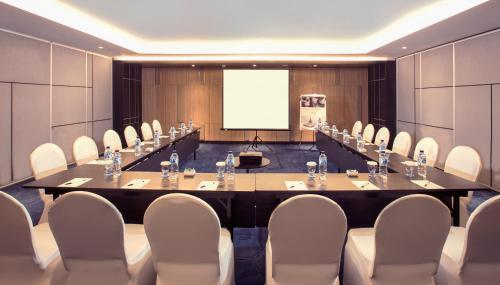 a conference room with a large table and chairs at Mercure Bandung City Centre in Bandung