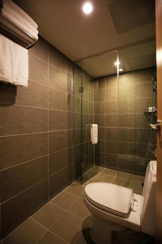 a bathroom with a toilet and a shower at Best Western Jeju Hotel in Jeju