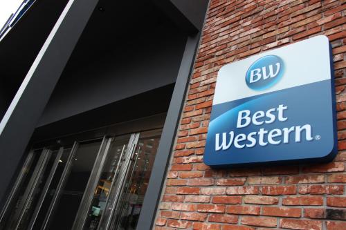 a sign for the best western sign on a building at Best Western Jeju Hotel in Jeju