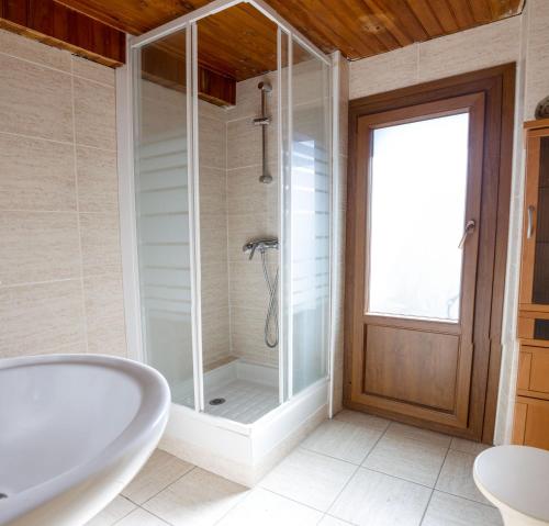 オセジャにあるla Cabaña de la Foretのバスルーム(バスタブ、ガラス張りのシャワー付)