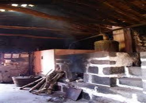 a brick fireplace in a room with at Yes Pico in Santa Luzia