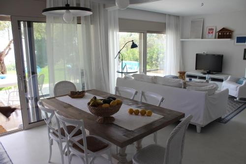 a living room with a table with fruit on it at Akti Elia Villas Beachfront Chalkidiki in Elia