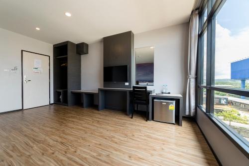 an apartment with a kitchen and a living room at Z Sleep Hotel in Hat Yai