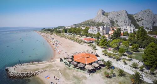 an aerial view of a beach with umbrellas at Seaview Apartment Tony with Grand Terrace in Omiš