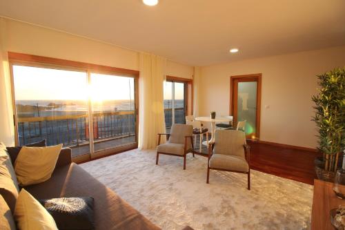 a living room with a couch and a table with chairs at Agudela Vista Mar in Lavra