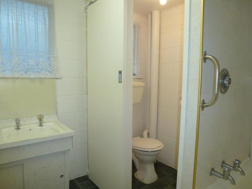 uma casa de banho com um WC e um lavatório em Lakeside Motel em Queenstown