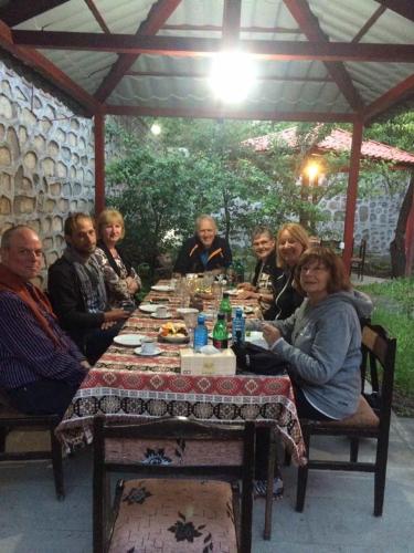 a group of people sitting around a table at Christy Hotel in Goris