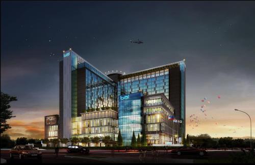 a large building with an airplane flying over it at bai Hotel Cebu in Cebu City
