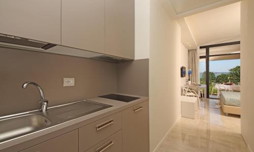 a kitchen with a sink and a counter top at Hotel Residence Holiday in Sirmione