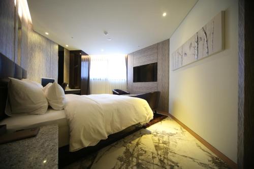 Un pat sau paturi într-o cameră la First Hotel