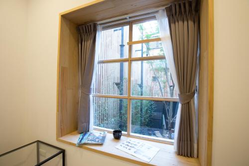 a window with a view of a city at Atreeium in Tainan